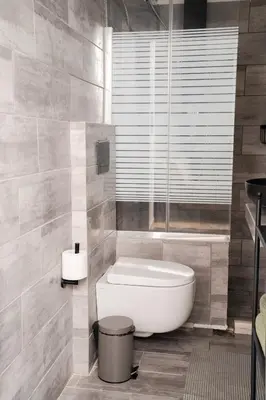 a bathroom with a tub and a toilet in it at Tsigros Apartments B in Athens