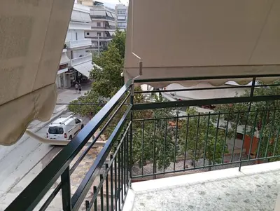 a white car parked on a balcony next to a building at Tataoulon 22, Nea Smirni in Athens