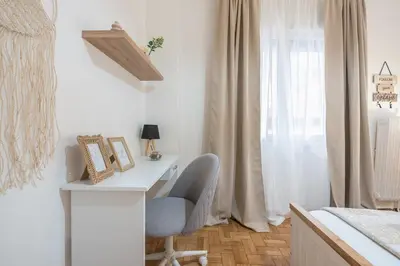 a desk and a chair in a room with a window at Ble Elia Thiseio Suite in Athens