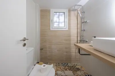 a bathroom with a toilet and a sink at Ble Elia Thiseio Suite in Athens