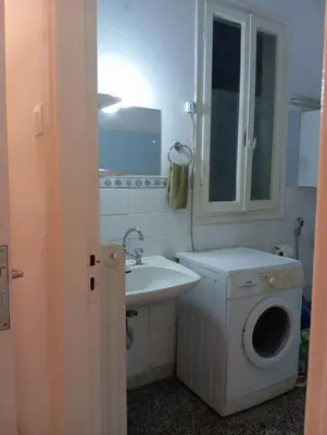 a bathroom with a washing machine and a sink at Room for 2 in a dormitory 5' from metro in Athens