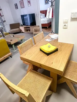 a wooden table and chairs in a living room at Urban comfort in Athens centre in Athens