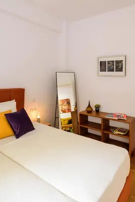 a bedroom with a bed and a desk and a mirror at Urban comfort in Athens centre in Athens
