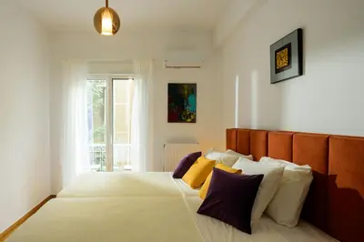 a bedroom with a bed with yellow and purple pillows at Urban comfort in Athens centre in Athens
