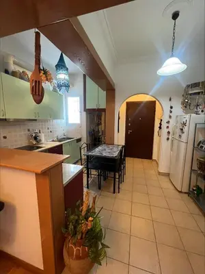 a kitchen with a table and a dining room at Bohemian Athens home in Athens