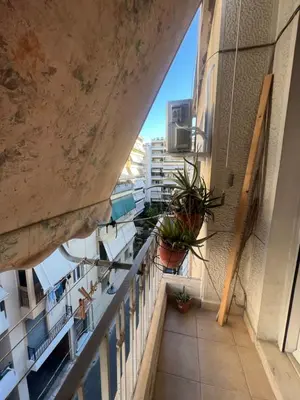 a balcony with potted plants on a building at Bohemian Athens home in Athens