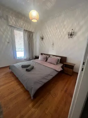 a bedroom with a large bed in a room at Bohemian Athens home in Athens