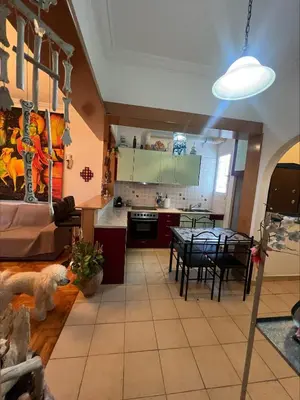 a kitchen and dining room with a dog laying on the floor at Bohemian Athens home in Athens