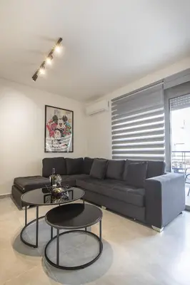 a living room with a couch and two tables at Black & White 2BR Apt steps from Mavili Square in Athens