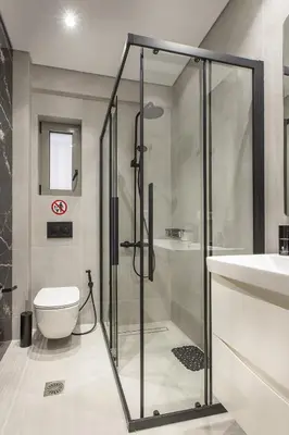 a bathroom with a shower and a toilet and a sink at Black & White 2BR Apt steps from Mavili Square in Athens