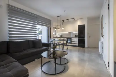a living room with a couch and a table at Black & White 2BR Apt steps from Mavili Square in Athens