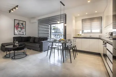 a kitchen and living room with a table and chairs at Black & White 2BR Apt steps from Mavili Square in Athens