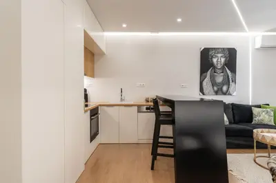 a kitchen and living room with a couch and a table at Ilisia Urban Elegance in Athens