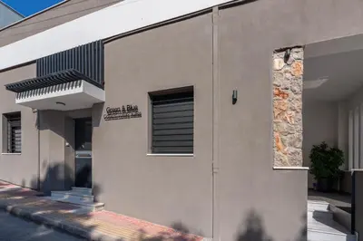 a building with a sign on the side of it at 'Green & Blue' Castella Luxury Suites in Piraeus