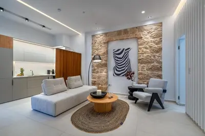 a living room with a couch and two chairs and a table at 'Green & Blue' Castella Luxury Suites in Piraeus