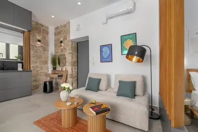 a living room with a couch and a table at 'Green & Blue' Castella Luxury Suites in Piraeus