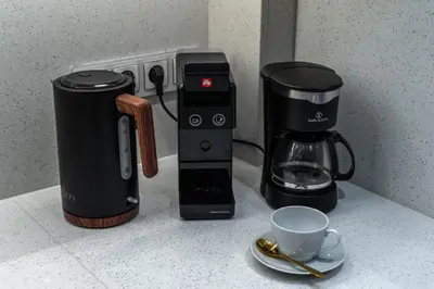 a coffeemaker and a coffee maker on a counter at 'Green & Blue' Castella Luxury Suites in Piraeus