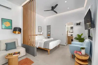 a bedroom with a bed and a living room at 'Green & Blue' Castella Luxury Suites in Piraeus