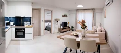 a kitchen and a living room with a table and chairs at Sweet Family Home 1 in Athens