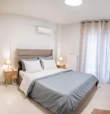 a bedroom with a large bed and two night stands at Sweet Family Home 1 in Athens