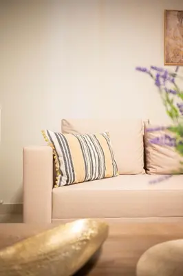 a white couch with pillows in a living room at Sweet Family Home 1 in Athens