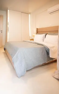 a bedroom with a large bed with white pillows at Sweet Family Home 1 in Athens