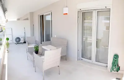 a room with a table and chairs on a balcony at Sweet Family Home 1 in Athens