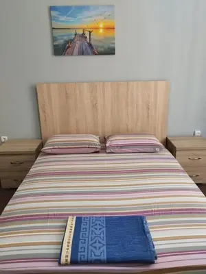 a bed with two books sitting on top of it at Apartment Atiki metro shared bathroom and kitchen in Athens