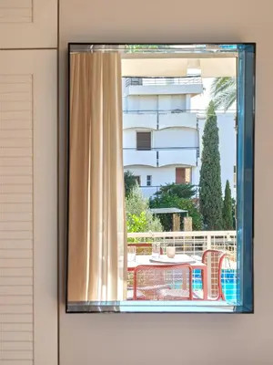 a window with a view of a building at 12LVE Vouliagmeni Apartment in Athens