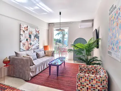 a living room with a couch and a table at 12LVE Vouliagmeni Apartment in Athens