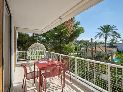 a patio with a table and chairs on a balcony at 12LVE Vouliagmeni Apartment in Athens
