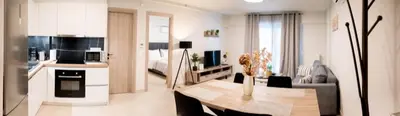 a kitchen and living room with a table in a room at Sweet Family Home 3 in Athens