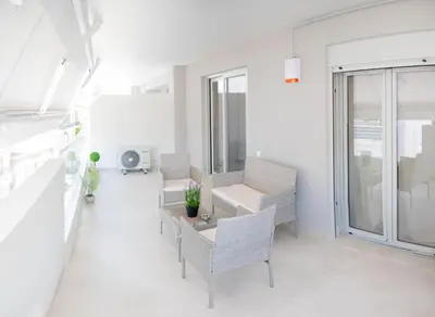 a white living room with chairs and a table and windows at Sweet Family Home 3 in Athens