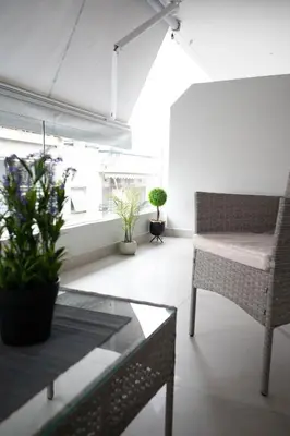 a living room with a table and chairs at Sweet Family Home 3 in Athens