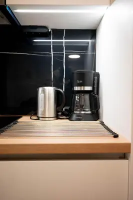 a coffee maker on a shelf in a microwave at Sweet Family Home 3 in Athens