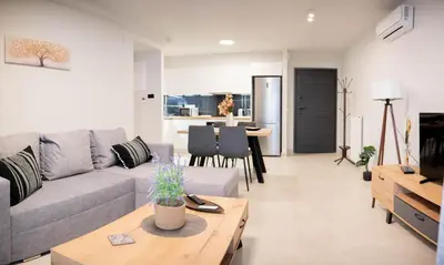 a living room with a couch and a table at Sweet Family Home 2 in Athens