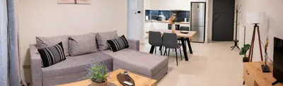 a living room with a couch and a table at Sweet Family Home 2 in Athens