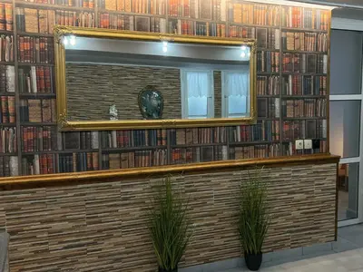 a mirror in a library with a lot of books at Filopappou Nest in Athens