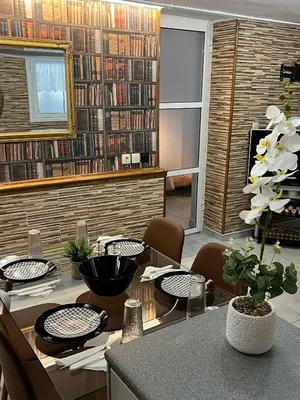 a living room with a table and chairs and a library at Filopappou Nest in Athens