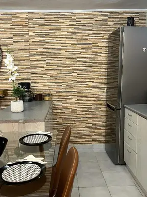 a kitchen with a table and a refrigerator at Filopappou Nest in Athens