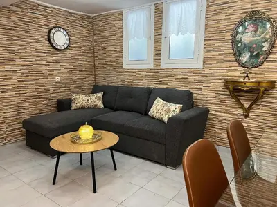 a living room with a couch and a table at Filopappou Nest in Athens