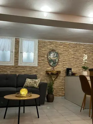 a living room with a couch and a table at Filopappou Nest in Athens