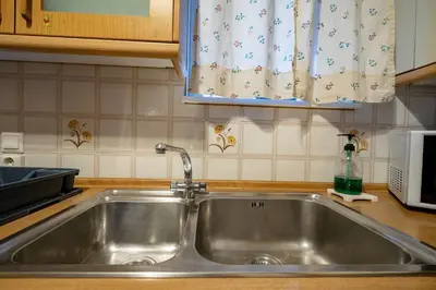 a stainless steel sink in a kitchen with a window at 3BRM Flat in Chalandri - Near Metro by ΜΡS in Athens