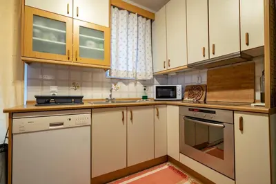 a kitchen with white cabinets and a stove top oven at 3BRM Flat in Chalandri - Near Metro by ΜΡS in Athens