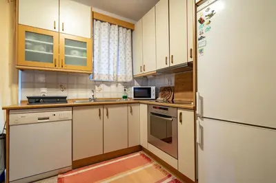 a kitchen with white cabinets and a refrigerator at 3BRM Flat in Chalandri - Near Metro by ΜΡS in Athens