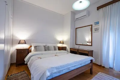 a bedroom with a large bed and a mirror at 3BRM Flat in Chalandri - Near Metro by ΜΡS in Athens
