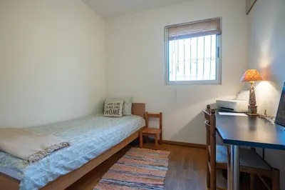 a bedroom with a bed and a desk and a window at 3BRM Flat in Chalandri - Near Metro by ΜΡS in Athens