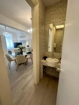 a bathroom with a sink and a dining room at elan RESIDENCE in Athens