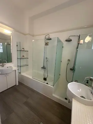 a bathroom with a glass shower and a sink at elan RESIDENCE in Athens