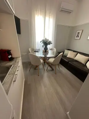 a small living room with a table and a couch at elan RESIDENCE in Athens